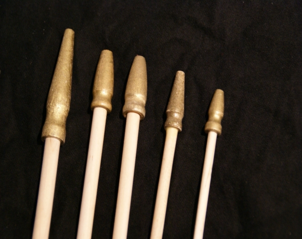 Five Wooden Flag sticks with wood Gilt Spear tips attached to one end, in a variety of diameters